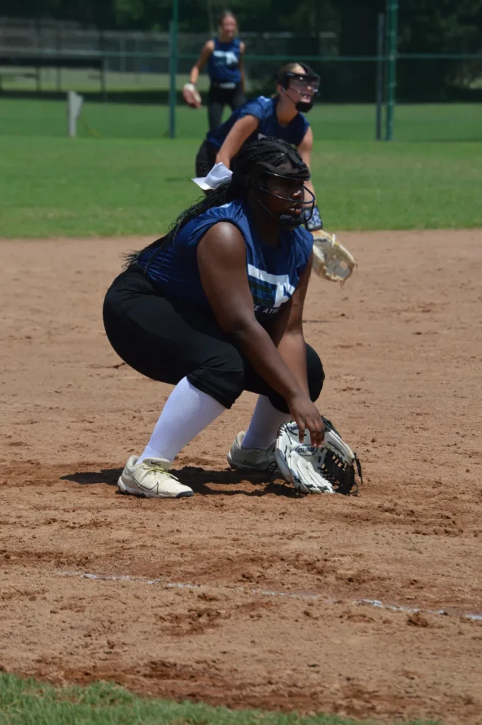 jayden squatting down to get ball