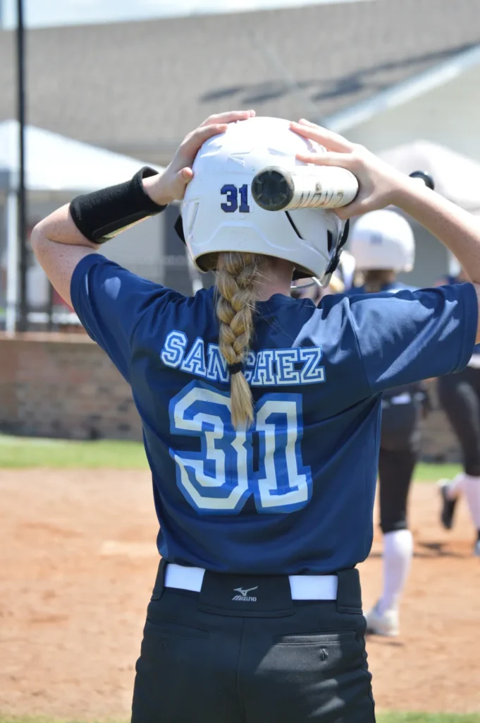kk from behind hands on helmet
